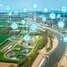 Een waterbehandelingsinstallatie, een rivier en een stad van bovenaf gezien met icoontjes die digitalisatie aangeven